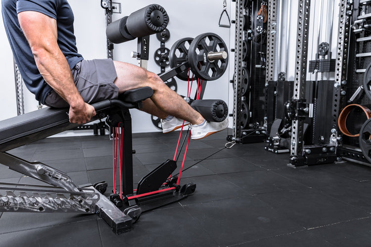 Athlete using the cable kit for cable resistance on the Leg Extension & Leg Curl Bench Attachment