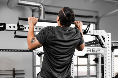 Athlete doing a pull-up on the REP Fitness Crossmember Pull-Up Bar
